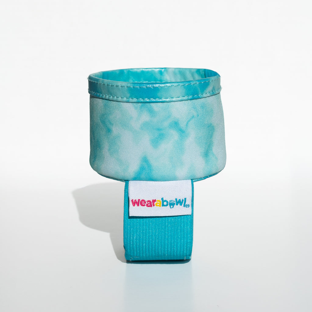 Turquoise pet bowl with a strap and 'Wearabowl'.
