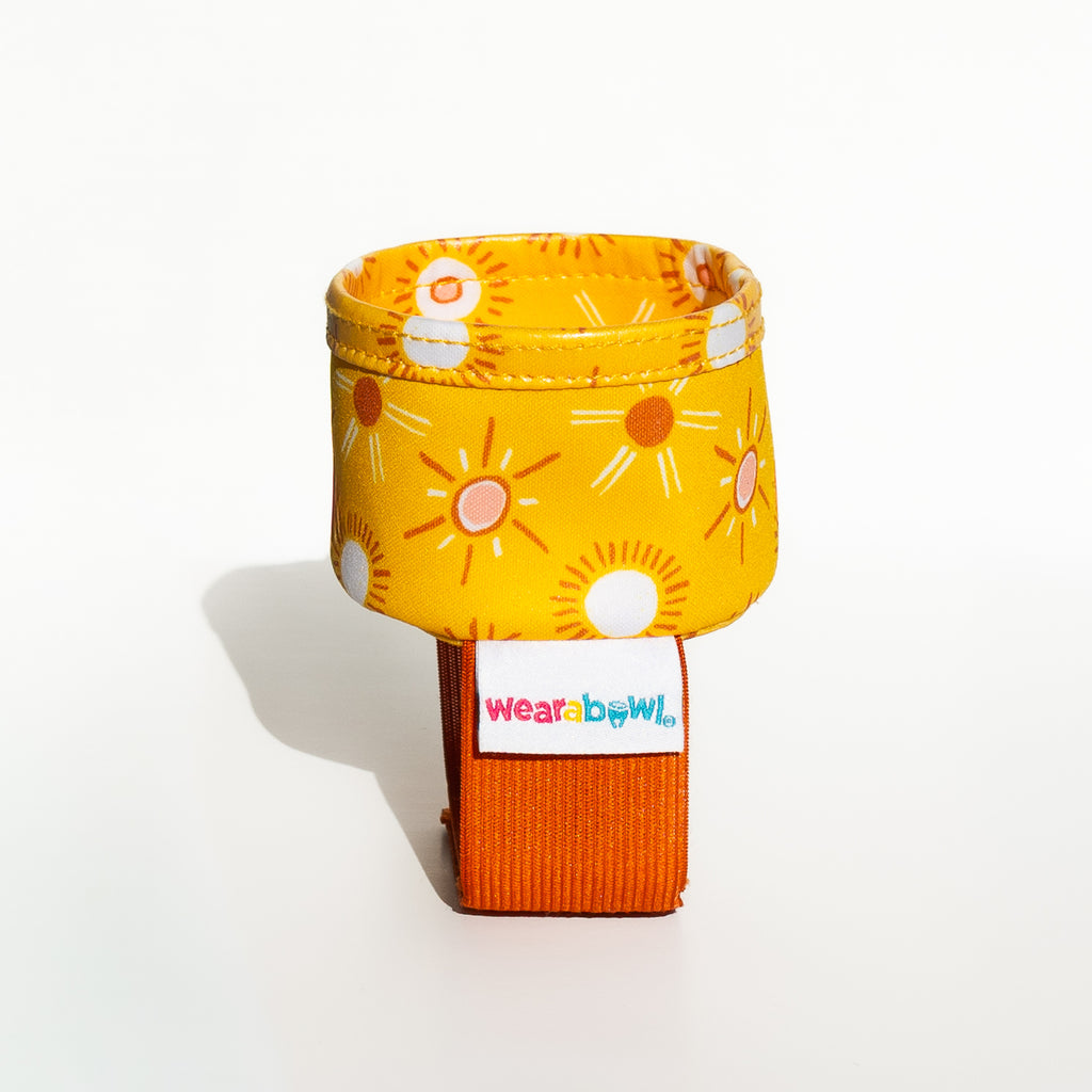 Yellow and orange baby bowl with sun pattern.