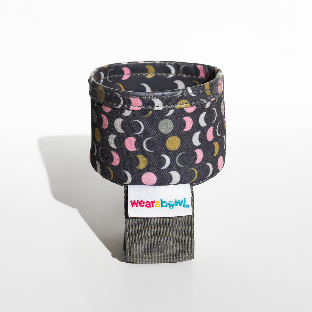 Wearable bowl with patterned strap and visible brand label.