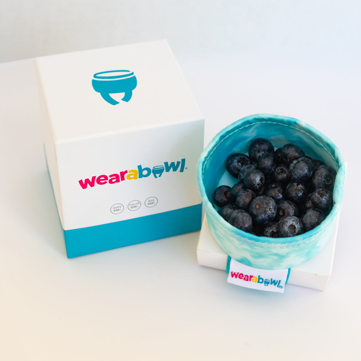 Wearabowl packaging with a container of blueberries.